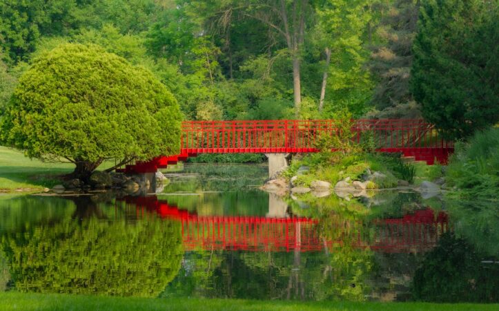 a red bridge over the pond at dow gardens midland michigan united states